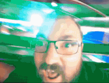 a man with glasses and a beard looks surprised