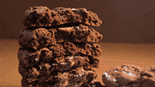 a close up of a stack of chocolate cookies with a bite taken out of one