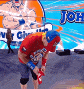 a man in a red shirt with the word john on the front