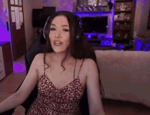 a woman wearing headphones sits in a chair