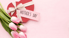 a heart shaped gift box with a tag that says mother 's day on it