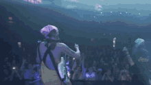 a man in a bandana is playing a guitar in front of a crowd at a concert