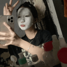 a woman with a white mask on her face takes a selfie