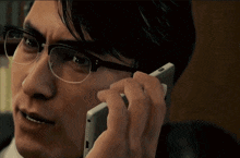 a man wearing glasses talking on a cell phone