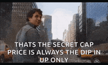 a man is standing in front of a city and says that the secret cap price is always the dip in up only