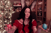 a girl with bunny ears holds two eggs in her hands