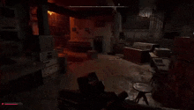 a video game is being played in a dark room with blood coming out of the floor .