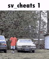a man in a red shirt is walking towards a white car in a yard .
