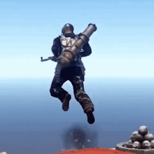 a man in a helmet is jumping in the air holding a rocket launcher