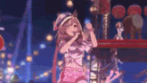 a girl is singing into a microphone while standing on a stage in front of a crowd .