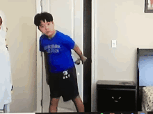 a boy in a blue shirt that says abercrombie & fitch