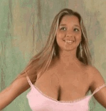 a woman in a pink tank top is smiling