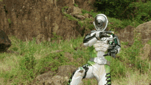 a person in a green and white costume with a camera on their head