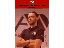 a man stands with his arms crossed in front of a sign that says amphi de presentation and pot