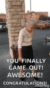 an elderly woman is dancing in front of a brick wall and says `` you finally came out awesome ! ''