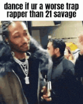 a man is standing in front of a crowd of people and talking to another man .