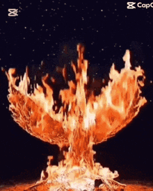 a large fire is coming out of a hole in the ground