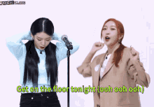 two women are singing into microphones with the words get on the floor tonight ooh ooh ooh