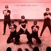 a group of men are dancing in front of a sign that says t.i.p. crew