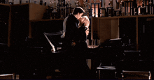 a man and woman kissing in a dark room