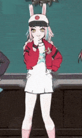 a girl wearing a bunny hat and a red jacket is standing in front of a green wall