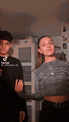 a boy and a girl are posing for a tiktok