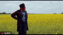 a man standing in a field of yellow flowers with a vlipsy logo in the corner