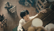 a young boy looks up at something in a room