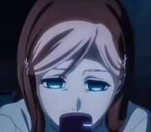 a close up of a girl 's face with a cell phone in her mouth
