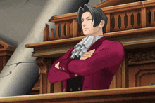 a man in a red suit stands with his arms crossed in a courtroom