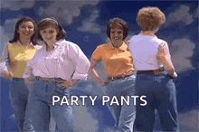 a group of women wearing party pants are dancing together .