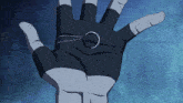 a person 's hand is holding a ring with a chain around it