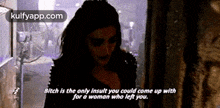 a woman is standing in a dark room with a quote that says bitch is the only insult you could come up with