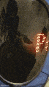 a person is taking a picture of themselves in a mirror with the letter p on the lens