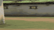 a pixelated image of a person holding a gun in front of a wall