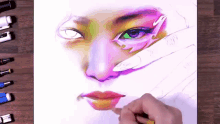 a person is painting a woman 's face with a pencil