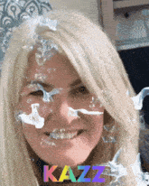 a woman with bubbles on her face and the word kazz in the corner