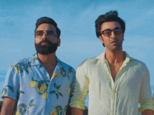 two men are standing next to each other wearing sunglasses and shirts with lemons on them