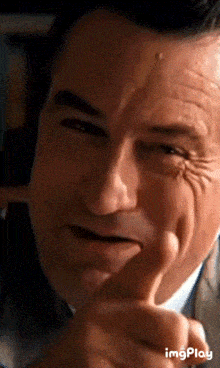 a close up of a man 's face with the word imgplay visible