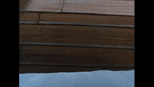 a close up of a wooden surface with a white cloth on it