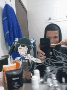 a man is brushing his teeth in front of a mirror with a picture of a girl in the background