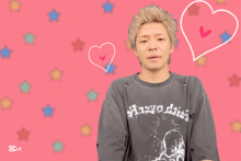 a man wearing a t-shirt that says ' anapodia ' on it stands in front of a pink background