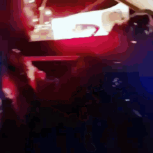 a blurry picture of a person standing in front of a car