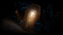 a shield with a cross on it is sitting in front of a robot
