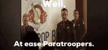 a group of men standing in front of a sign that says pop b