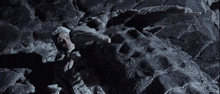 a person is laying on a rock with a very large head