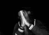 a man wearing headphones is praying with his hands together