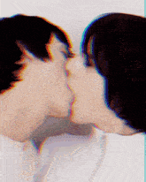 a man and a woman kissing with a blurry background