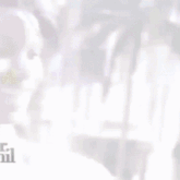 a man in a suit and tie is smiling and looking down