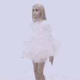 a woman in a white dress is standing in the clouds